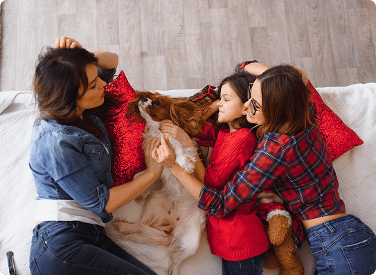 Family with dog on bed